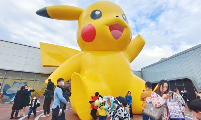 Visitors view a 10-meter tall glass and steel Pikachu sculpture in Shanghai, China, on November 28, 2021.
