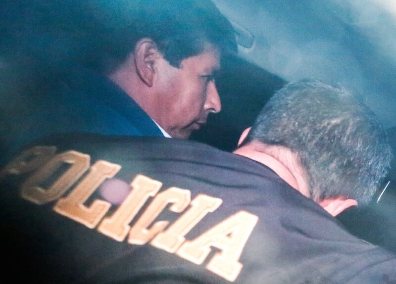 Peru's ousted President Pedro Castillo is escorted by police in Lima, Peru, on Dec. 7, 2022. (Renato Pajuelo / AP)