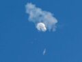 An object, suspected to be a spy balloon, is seen in the sky.