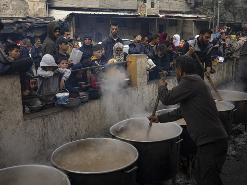 Palestinians line up for a free meal in Rafah, Gaza Strip, Thursday, Dec. 21, 2023.